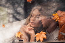 Young Happy Lovers Couple Behind Wet Misted Window,rain Drops.Drawing Heart With Finger.Autumn Atmosphere,mood,maple Leaves.Love Romantic Road Travel. Traveling In Camper,house On Wheels,trailer