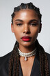 © face_reader_img - Portrait of African American woman with long braids wears pearls necklace.