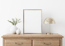 Vertical Wooden Frame Mockup In Traditional Living Room Interior With Classic Chest Of Drawers, Brass Lamp And Olive Twigs In Vase On White Wall Background. Illustration, 3d Rendering