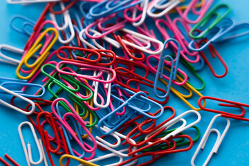 Wall Mural - close up view of colorful paper clips on blue.