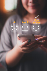 woman using smart phone Customer satisfaction concept with smile icon