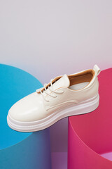 Trendy leather female sneakers. White milky color,