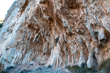 The karst calcareous rock formation of the the steep cliff above the coastal town Positano, Amalfi Coast, Italy, Campania, Europe. Geostructural carbonate rocks in Apennine mountains. Path of the Gods