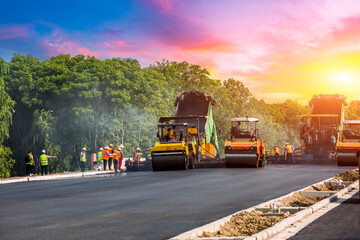 Wall Mural - Construction site is laying new asphalt pavement. road construction workers and road construction machinery scenery. Highway construction site scene in China.