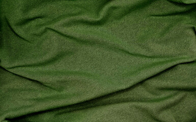 Wall Mural - crumpled green olive sackcloth texture use as backgrounfd. natural mood of cloth texture. close up of coarse fabric for backdrop. creases on fabric with blank space for design.