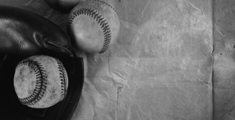 Wall Mural - Old vintage baseball equipment shows used game balls with glove on nostalgia wallpaper texture background.