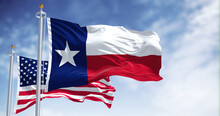 The Texas State Flag Waving Along With The National Flag Of The United States Of America
