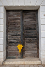 Doorway In Italy With A Yellow Umbrella