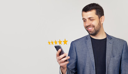 Businessman giving a five star rating. Customer service experience and business satisfaction survey. Businessmusing smart phone with icon five star symbol to increase rating of company concept