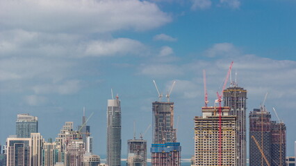 Wall Mural - High multi-storey buildings under construction and cranes timelapse