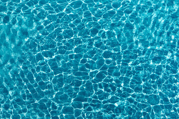  Beautiful blue crystal clear water texture with small ripples on the surface.