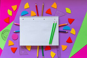 Wall Mural - School supplies, open notepad, rulers, fractions on a violet background. Interesting, fun math for kids. Education, back to school concept