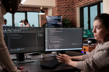 Programmers looking for source of cyber attacks and system security coverage. Software developer team members programming encryption applications to be used as security measure.