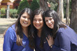 © Arlette - Three professional, accomplished, confident, empowered, strong Latin women sisters with straight hair dressed in blue are in a park sharing their happiness and spending time with their family