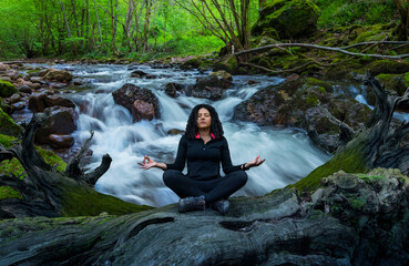 Wall Mural - woman doing yoga in front of a waterfall