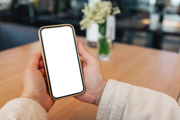 Close-up of a phone with a screen in hands in a cafe on the street