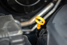 Car Or Machinery Engine Oil Level Stick With Pulling Handle In Yellow Color. Transportation And Industrial Equipment Part Object Photo. Selective Focus.