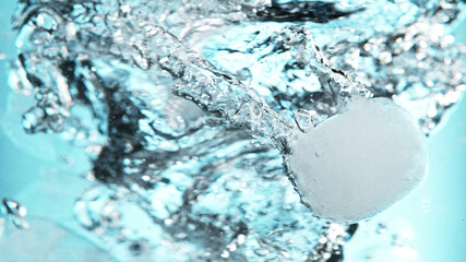 Canvas Print - Close up of ice cubes underwater, blue background.