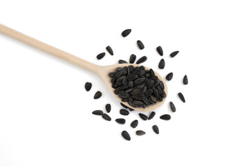 wooden spoon with sunflower seeds isolated on white