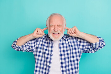 Sticker - Photo of grandfather suffering from loud noise cover his ears with fingers isolated on turquoise color background