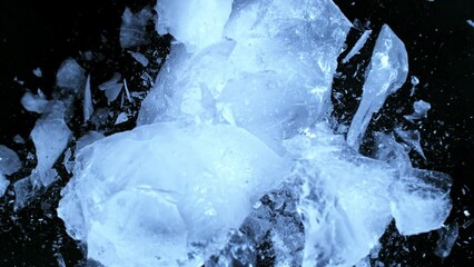Aufkleber - Super slow motion of falling piece of ice on black background. Filmed on high speed cinema camera, 1000 fps.