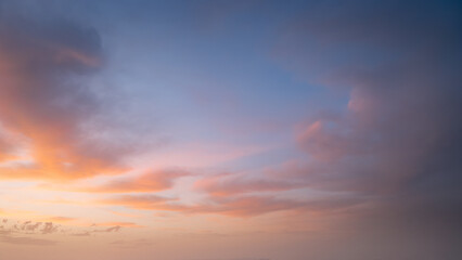 Wall Mural - colorful pastel sky with clouds at beautiful sunset as natural background.