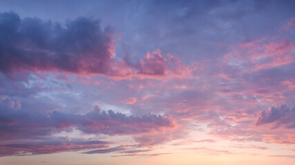 Pink sky with clouds at beautiful sunset as natural background.