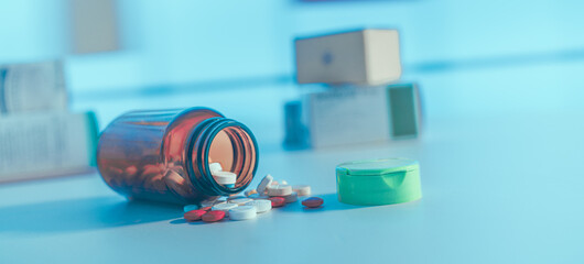 Poster - Medical pills and tablets spilling out  drug bottle. View with copy space.