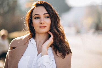 Portrait of woman in white shirt and coat