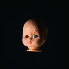 Damaged Dirty Doll Head On Black Background