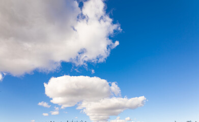 Wall Mural - wonderful white clouds in blue sky background in the afternoon with a sunny day in the summertime in Denmark
