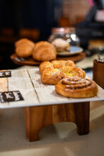 Close-up Of Croissants, Danish Pastries And Cinnamon Swirls For Sale In A Cafe