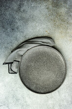 Overhead View Of A Grey Ceramic Plate And Napkin On A Table