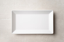 Rectangular White Plate On A Light Stone Background, The Concept Of Food, Restaurant
