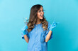 © luismolinero - Woman dentist holding tools over isolated on blue background intending to realizes the solution while lifting a finger up