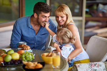 Wall Mural - Child feeds her father with grape