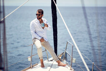 Casual Attractive Man Sailing Alone; Luxurious Lifestyle Concept