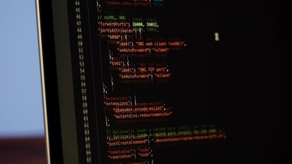 Programmer using laptop. Program code and script data on the screen close-up. Hacker attack. 