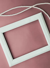 Poster - Horizontal art frame and pearl jewellery on blush pink background as flatlay design, artwork print or photo album