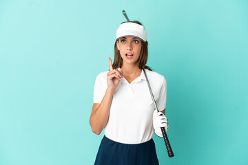 Woman playing golf over isolated blue background thinking an idea pointing the finger up