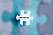 Improvise word on puzzle pieces isolated on blurred blue background.