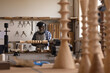 © Wavebreak Media - African american mature carpenter wearing safety face shield shaping and carving wood in workshop