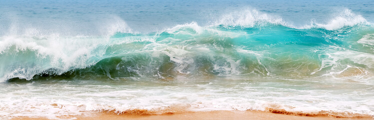Wall Mural - Blue and aquamarine color sea waves and yellow sand with white foam. Marine beach background. Banner format.
