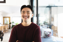 Potrait Of Confident Young Asian Man Smiling At Home
