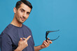 © SHOTPRIME STUDIO - handsome man in blue t-shirt 3d glasses entertainment gesture with hands cropped view