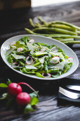 Wall Mural - Food photography. Green salad with fresh vegetables, asparagus and radishes