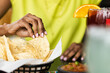 © Sean Locke/Stocksy - Cinco: Woman Eating Fresh Chips And Salsa