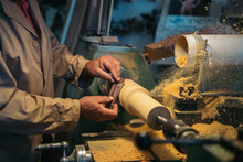 Carpenter Using Lathe Machine For Grinding