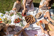 © Andriy Bezuglov/Stocksy - Family picnic on nature with berries and sweets