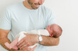 © Alison Winterroth/Stocksy - Dad in blue shirt smiles at his son